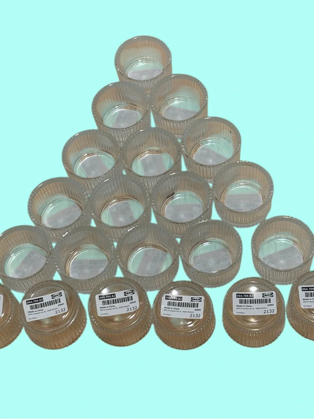 21 IKEA FINSMAK clear glass tealight holders.